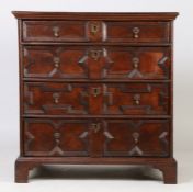 A Charles II oak geometric chest of drawers, circa 1680, the rectangular top above four long drawers