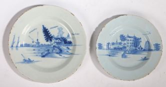 Two 18th Century Delft plates, both painted in blue, one with a farm and windmills, 27cm diameter