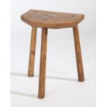 A Welsh oak stool, the rectangular top with canted corners to one side above three tall angled legs,