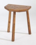 A Welsh oak stool, the rectangular top with canted corners to one side above three tall angled legs,