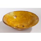 A large 19th Century French bowl, in mustard yellow glaze with a flared lip, 29.5cm diameter