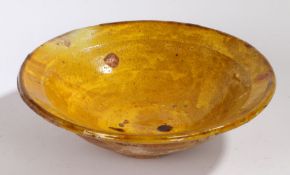 A large 19th Century French bowl, in mustard yellow glaze with a flared lip, 29.5cm diameter