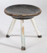 A 19th Century painted stool, the black painted circular dished top above three white painted turned