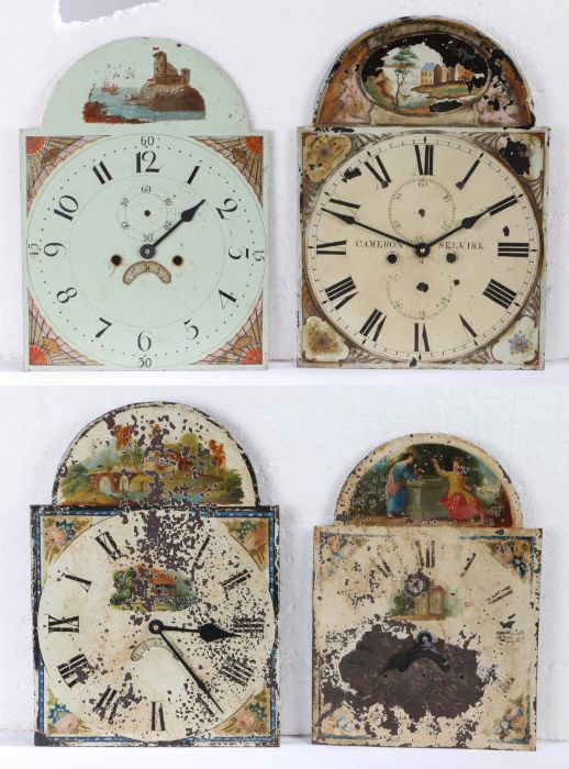 A collection of four long case clock painted dials, each fitted with a later battery powered