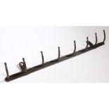 A 19th Century hook rack, with eight arms, 79cm wide