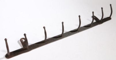 A 19th Century hook rack, with eight arms, 79cm wide