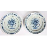 Pair of 18th Century Delft plates, circa 1760, each with a vase and bouquet of flowers with