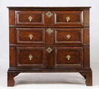 A late 17th Century oak geometric chest of drawers, the rectangular top above three graduated long