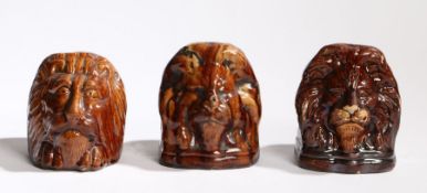 Three 19th Century sash window pottery jams, each in treacle glaze with lion masks, 10.5cm wide, (