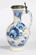 A 17th Century Delft  jug or ewer, circa 1660-80, painted in blues with rocks and flowers capped