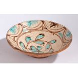 A large 19th Century French bowl, with a blue and brown flower to the centre and a geometric edge,