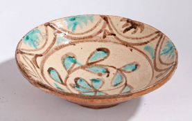 A large 19th Century French bowl, with a blue and brown flower to the centre and a geometric edge,