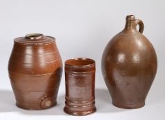 A large 19th Century brown glaze jug, in the Bellarmine form, 47cm high, together with a pottery