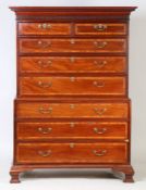 A George III mahogany and satinwood banded chest on chest, the rectangular top above a dentil