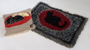 A 20th Century rag rug, centred by a black cat within a red oval and grey/blue field, together