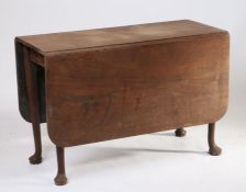 A George III mahogany drop leaf dining table, the rectangular top above tapering legs and pad