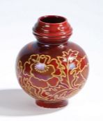 A Craven Dunhill, Jackfield lustre vase, with a red ground and stylised flowers among leaves, signed