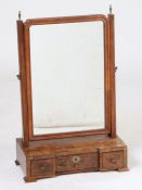 A George I walnut toilet mirror, the rectangular mirror plate flanked between two uprights and