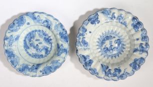 Two 17th Century Dutch Delft lobed dishes, both with a central Oriental figural scene and borders,