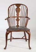 A 19th Century ash Windsor chair, the arched top rail with central splat and spindles above a