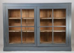 A French shop display cabinet, later grey painted top and glazed doors enclosing shelves, 196cm