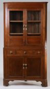 A George III oak standing corner cupboard, the concave cornice above a pair of glazed doors