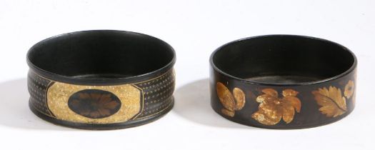 Two Regency papier mache coasters, the first with a black ground decorated with gilt flowers and