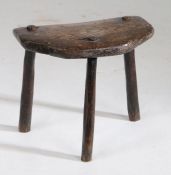 A 19th Century Welsh oak stool, the rectangular top with two canted corners above angled legs,
