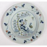 An 18th Century Delft plate, circa 1750, with a stork standing by a tree and flowers, 22,5cm