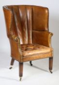 A 19th Century leather upholstered barrel back armchair, the arched pad back above a cushion seat