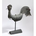 A zinc weathervane, in the form of a cockerel, with a plump body on a later stand, 69cm long