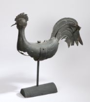 A zinc weathervane, in the form of a cockerel, with a plump body on a later stand, 69cm long