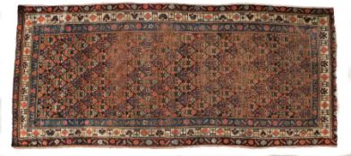 Kurdish rug, north west Persia, decorated with repeating floral motif to the centre and with