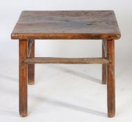 A Chinese table, the one piece top above circular legs united by stretchers, 73cm wide, 72cm deep,