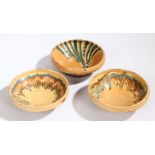 Three 19th Century French pottery bowls, with Mocha type glaze and pale orange ground, 17cm