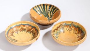 Three 19th Century French pottery bowls, with Mocha type glaze and pale orange ground, 17cm