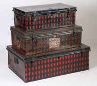 A matched set of three traveling tin trunks, painted in black and red, to include Elephant Brand,
