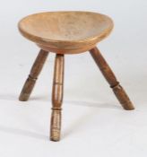 A 19th Century Welsh sycamore and ash stool, the circular dished top above three ring turned