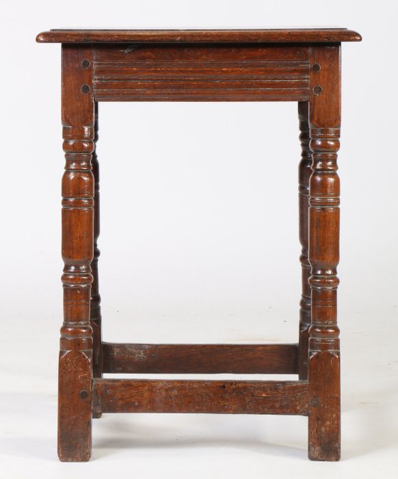 A Charles I oak joint stool, circa 1640 and later, the later rectangular top above turned legs