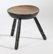 A 19th Century Welsh beech and black painted stool, the circular dished top above three ring