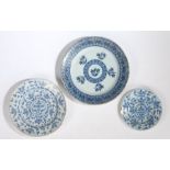 An 18th Century English Delft charger, painted in blue with flower sprigs and geometric borders,