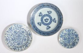 An 18th Century English Delft charger, painted in blue with flower sprigs and geometric borders,