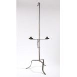 An 18th Century steel dual candle holder, the hook top above an adjustable candle stand and tripod