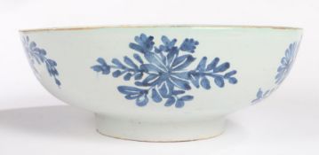 An 18th Century English Delft bowl, with a blue flower design and internal with flower sprig to