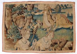 A 17th/18th Century Flemish tapestry fragment, with figures in period costume in a garden with dogs,