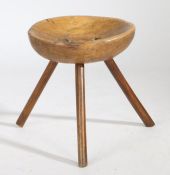 A 19th Century Welsh beech stool, the circular dished top above three turned angled legs, 34cm wide,