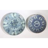 Two 18th Century Delft chargers, the first with painted in blue with a Chinese table and