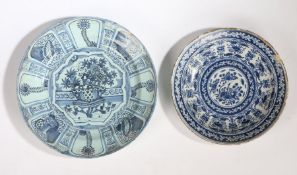 Two 18th Century Delft chargers, the first with painted in blue with a Chinese table and