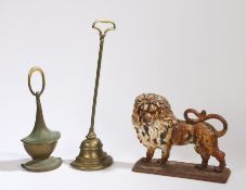 A 19th Century cast iron doorstop, as a standing lion, 28cm long, together with two further 19th