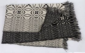 A Welsh blanket, a white and black geometric design, 185cm x 225cm approximately
